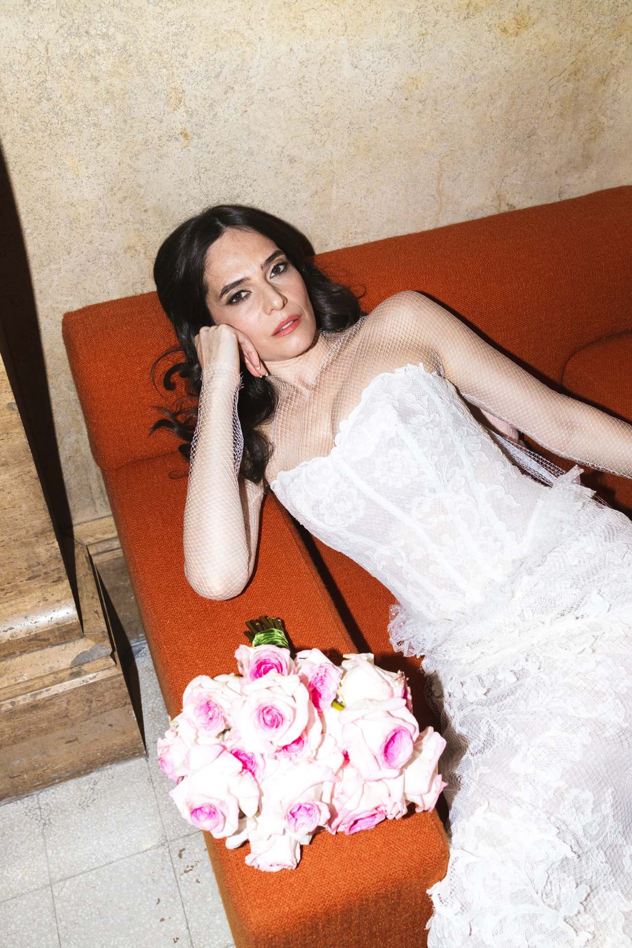 Bride resting on a velvet sofa